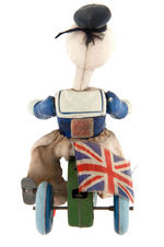 DONALD DUCK ON TRICYCLE WIND-UP WITH BRITISH UNION JACK FLAG.