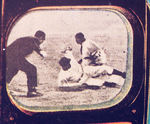 "GENERAL ELECTRIC TV" SIGN WITH BASEBALL IMAGE ON SCREEN.