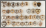 WWII EXTENSIVE COLLECTION OF MILITARY SERVICE LOGO HEART SHAPED LOCKETS AND CHARMS.