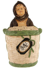 HOODED GIRL IN BASKET FIGURAL TOBACCO JAR.