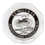 "CARRIAGES & HARNESS" GLASS ADVERTISING PAPERWEIGHT.