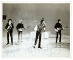 THE ROLLING STONES NEWS SERVICE PHOTO SIGNED BY FIVE ORIGINAL MEMBERS.